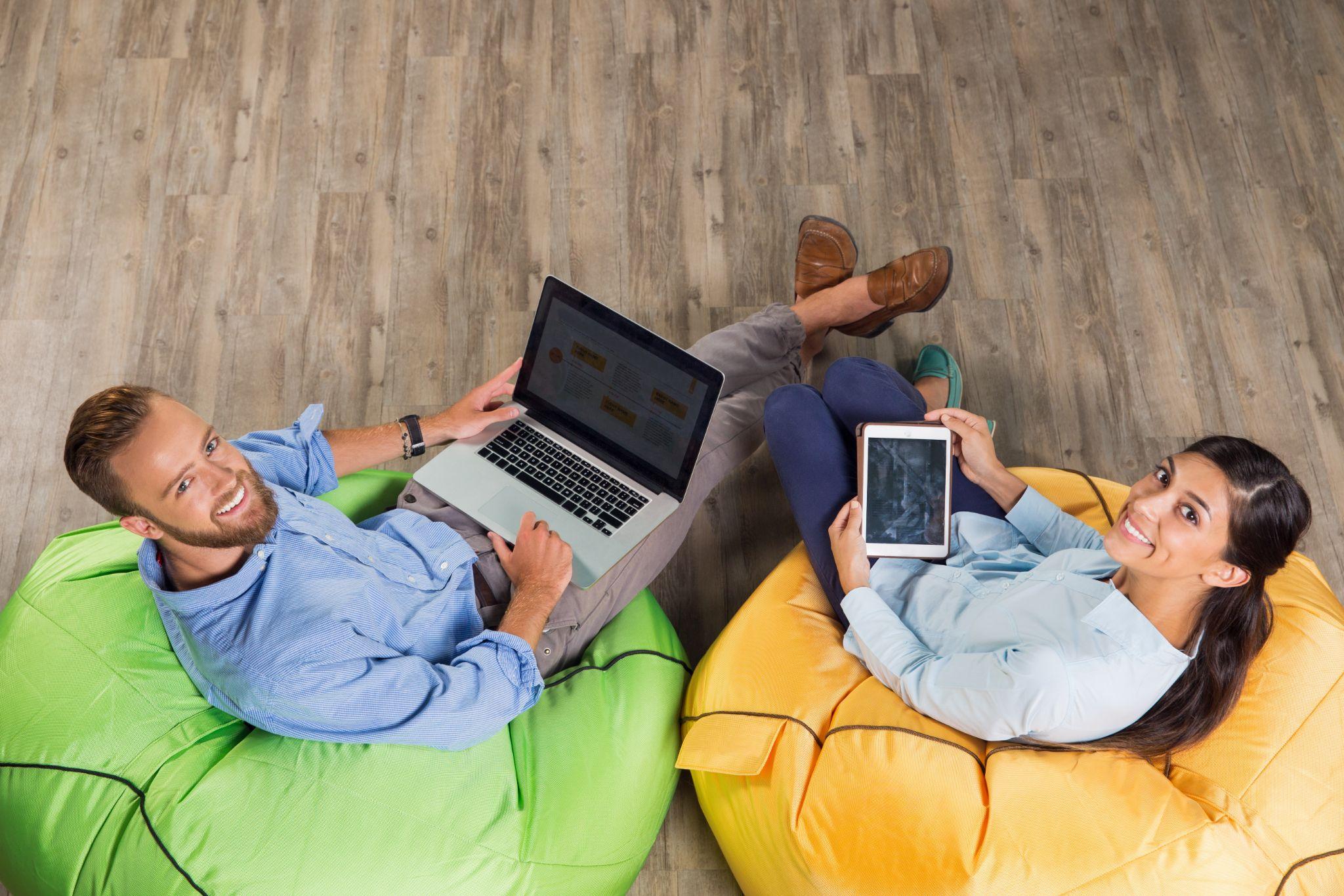 People using connected devices at home while comparing fiber and cable internet