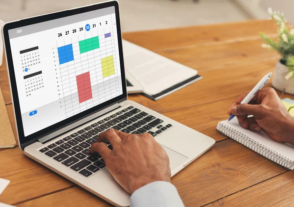 Business owner organizing technology and asset-management plans on a laptop