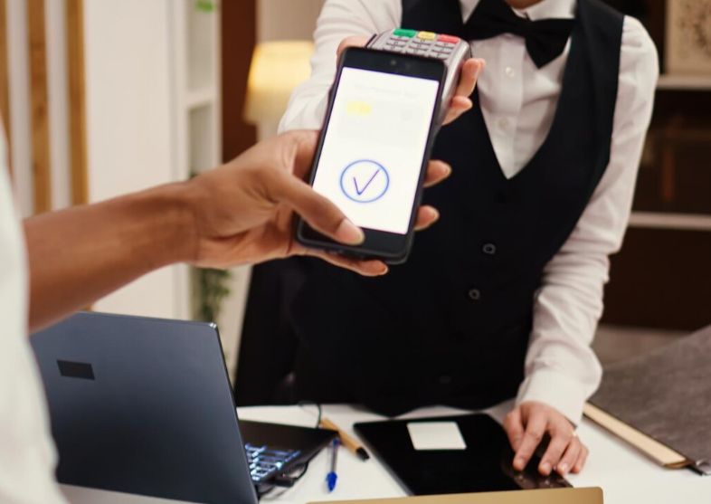 Customer using a smartphone to check in at a hotel reception