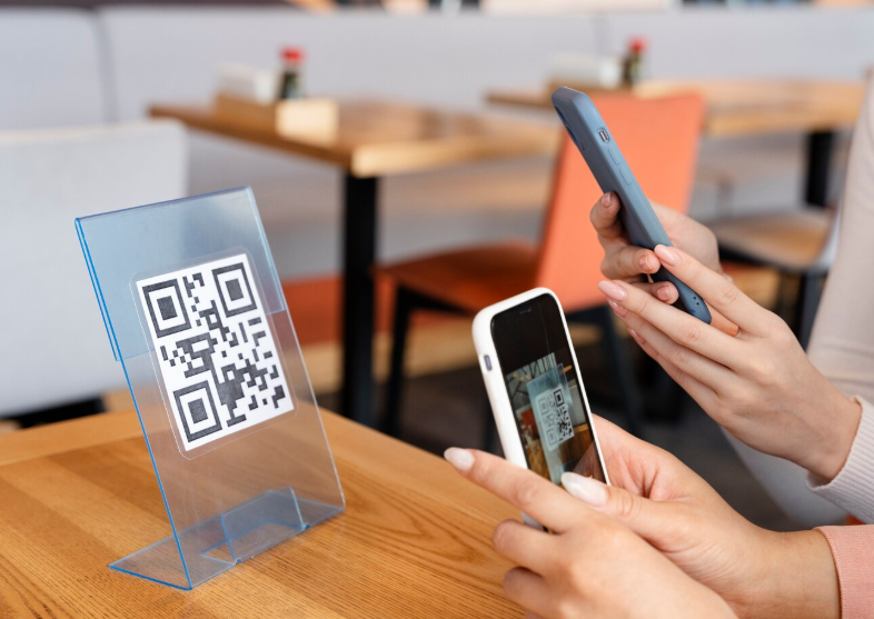 Restaurant guests scanning a QR code to view a digital menu