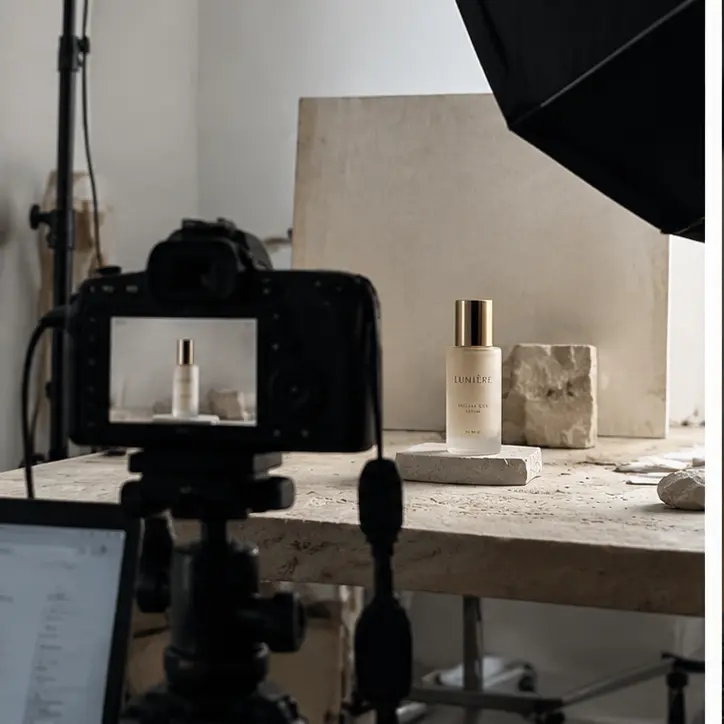 Illustrative studio setup photographing a skincare bottle