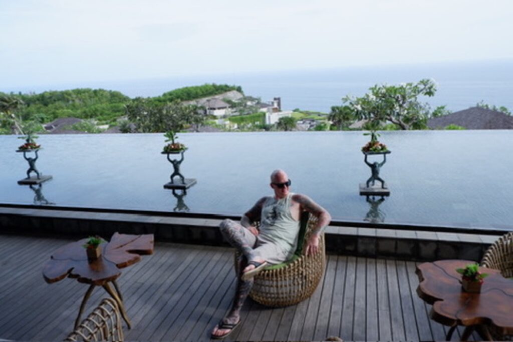 Trevor relaxing on a deck overlooking the water in Bali.