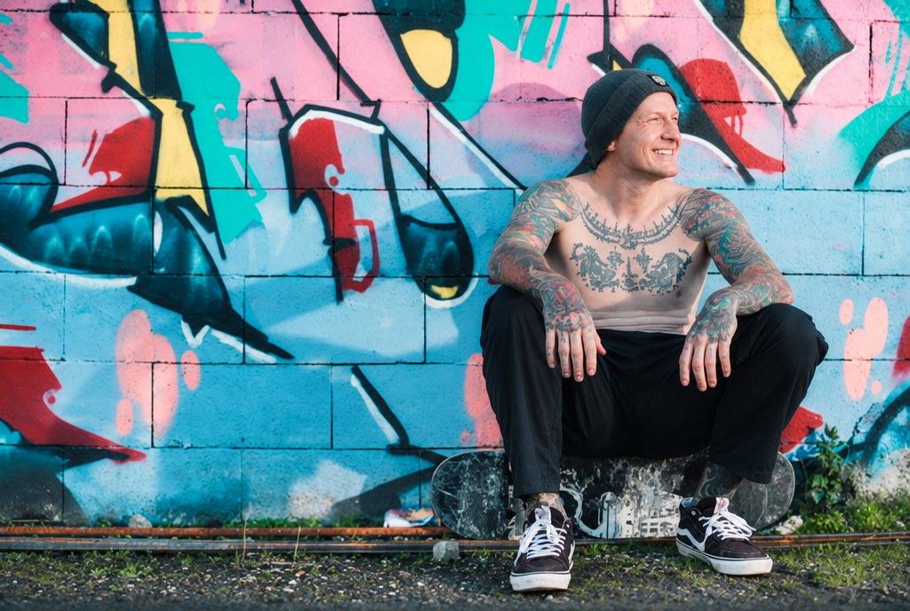 Trevor Fenner in front of a mural